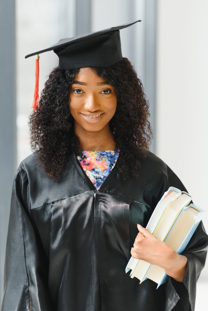 beautiful african female student with graduation certificate