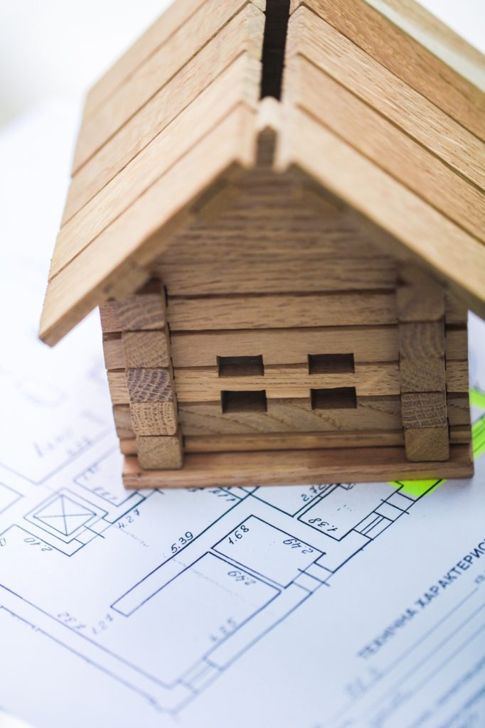 Building house on blueprints with plan - construction project